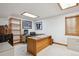 Office with a desk, wooden bookshelf, and carpeted floor creates a functional and inviting workspace at 7354 S Robb St, Littleton, CO 80127