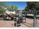 Community playground with modern climbing structure and slide, set in a safe and inviting environment at 7354 S Robb St, Littleton, CO 80127