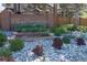 Elegant Woodbourne community sign surrounded by decorative stones, lush plants, and manicured landscaping at 7354 S Robb St, Littleton, CO 80127