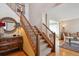 Elegant staircase with wood railings and carpeted steps, connecting the home's levels at 7354 S Robb St, Littleton, CO 80127