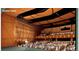 A spacious auditorium with a stage, layered side walls, and a full audience seated for a performance at 2857 S Pancratia St, Denver, CO 80236