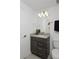 Well-lit bathroom featuring a modern vanity, stylish lighting, and a convenient layout at 2857 S Pancratia St, Denver, CO 80236