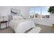 Bright bedroom featuring a large window, neutral decor, and a comfortable bed with soft, white linens at 2857 S Pancratia St, Denver, CO 80236