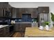 Modern kitchen featuring stainless steel appliances, dark cabinets, and a contrasting backsplash at 2857 S Pancratia St, Denver, CO 80236