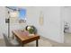 Office space with a wooden desk, neutral tones, and natural light from the window at 2857 S Pancratia St, Denver, CO 80236