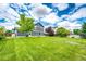 Expansive backyard featuring a lush green lawn and privacy fence, perfect for outdoor enjoyment at 1824 Asoka St, Strasburg, CO 80136