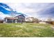Expansive backyard with lush green lawn and pergola, perfect for outdoor activities and relaxation at 1824 Asoka St, Strasburg, CO 80136