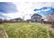 Large backyard with a well-maintained lawn and a view of the home's exterior at 1824 Asoka St, Strasburg, CO 80136