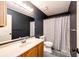 Bathroom featuring a tiled shower and a vanity at 1824 Asoka St, Strasburg, CO 80136