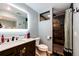 Modern bathroom featuring a vanity with a white marble countertop, a rainfall shower, and tile throughout at 1824 Asoka St, Strasburg, CO 80136