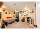 Bedroom features a neutral carpet, an electric fireplace, and lots of personalized wall art at 1824 Asoka St, Strasburg, CO 80136