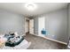Neutral bedroom with grey walls, carpet, natural light, closet space, and space for relaxation at 1824 Asoka St, Strasburg, CO 80136