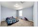 Cozy bedroom with blue walls, neutral carpet, and natural light offers a simple and comfortable retreat at 1824 Asoka St, Strasburg, CO 80136