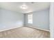 Light-blue bedroom with neutral carpet, window, and updated electrical outlets at 1824 Asoka St, Strasburg, CO 80136