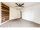 Spacious bedroom featuring a ceiling fan and doors at 1824 Asoka St, Strasburg, CO 80136