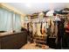 Spacious walk-in closet with ample storage, hanging rods, shelves, and a dresser at 1824 Asoka St, Strasburg, CO 80136