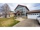 Charming two-story home featuring a well-maintained lawn, covered porch, and attached two-car garage at 1824 Asoka St, Strasburg, CO 80136