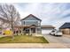 Inviting two-story home with a covered porch, spacious driveway, and attached garage for convenient parking at 1824 Asoka St, Strasburg, CO 80136