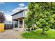 Charming home exterior featuring a well-manicured lawn, mature tree, and cozy front porch with lovely curb appeal at 1824 Asoka St, Strasburg, CO 80136