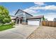 Beautiful home exterior with a large driveway and well-maintained lawn at 1824 Asoka St, Strasburg, CO 80136