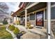 Charming front porch with seating, decorative plants, and inviting entrance to this lovely home at 1824 Asoka St, Strasburg, CO 80136