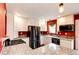 Modern kitchen featuring white cabinets, granite countertops, and stainless steel appliances at 1824 Asoka St, Strasburg, CO 80136