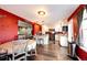 Modern kitchen with stainless steel appliances, granite countertops, white cabinets, and an eat in dining area at 1824 Asoka St, Strasburg, CO 80136