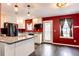 Modern kitchen with granite countertops, white cabinets, and stainless steel appliances at 1824 Asoka St, Strasburg, CO 80136