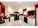 Modern kitchen with stainless steel appliances, granite countertops, and ample cabinet space for storage at 1824 Asoka St, Strasburg, CO 80136