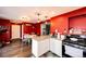 Bright kitchen with granite countertops, stainless steel appliances, and breakfast bar seating at 1824 Asoka St, Strasburg, CO 80136