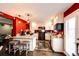 Modern kitchen with white cabinets, granite countertops, stainless steel appliances, and dark marble floors at 1824 Asoka St, Strasburg, CO 80136