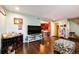 Spacious living room features hardwood flooring and ample natural light from a nearby doorway and staircase at 1824 Asoka St, Strasburg, CO 80136