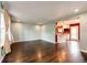 Open-concept living room with hardwood floors, neutral walls, and ample natural light at 1824 Asoka St, Strasburg, CO 80136