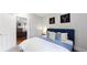 Bedroom with a view to the living room, hardwood floors, and stylish decor at 1137 Colorado Blvd, Denver, CO 80206
