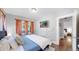 Comfortable bedroom featuring hardwood floors and a mounted TV at 1137 Colorado Blvd, Denver, CO 80206