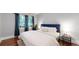 Bright bedroom featuring a comfortable bed with white linens and natural light from the window at 1137 Colorado Blvd, Denver, CO 80206