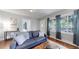 Bright living room featuring a gray sofa with decorative pillows and a large window for ample natural light at 1137 Colorado Blvd, Denver, CO 80206