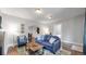 Inviting living room with a comfortable blue sofa, a decorative rug, and a doorway to the bedroom at 1137 Colorado Blvd, Denver, CO 80206