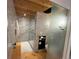 Modern bathroom with tile shower, glass door, and unique tile accents and light wood flooring at 24226 Currant Dr, Golden, CO 80401