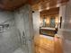 Bright bathroom featuring marble shower, double vanity, and light wood flooring at 24226 Currant Dr, Golden, CO 80401