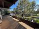 Relaxing outdoor deck area with wooden floors, decorative plants and scenic tree views at 24226 Currant Dr, Golden, CO 80401