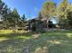 Secluded home surrounded by lush greenery and towering trees in a serene setting at 24226 Currant Dr, Golden, CO 80401