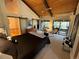 Relaxing primary bedroom features vaulted ceiling, walk-out balcony, and attached bathroom with sliding barn doors at 24226 Currant Dr, Golden, CO 80401