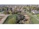 Scenic aerial view of the natural landscape with mature trees and foliage and a peaceful pond at 2949 Vivian St, Wheat Ridge, CO 80215