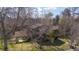 An aerial shot shows the house surrounded by mature trees at 2949 Vivian St, Wheat Ridge, CO 80215