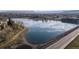 A panoramic aerial view captures the tranquil lake and walking trail, creating a picturesque neighborhood oasis at 2949 Vivian St, Wheat Ridge, CO 80215