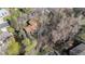 An aerial shot shows the house surrounded by trees, with some bordering a waterway at 2949 Vivian St, Wheat Ridge, CO 80215
