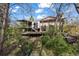 An exterior of a home featuring two decks with lush, mature landscaping surrounding the back of the home at 2949 Vivian St, Wheat Ridge, CO 80215