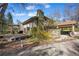 Exterior shot of a home with a deck, chimney and porte cochere at 2949 Vivian St, Wheat Ridge, CO 80215