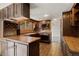Cozy kitchen featuring wood cabinetry, laminate countertops, and modern appliances at 2949 Vivian St, Wheat Ridge, CO 80215